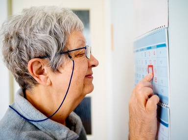Older woman looking at calendar