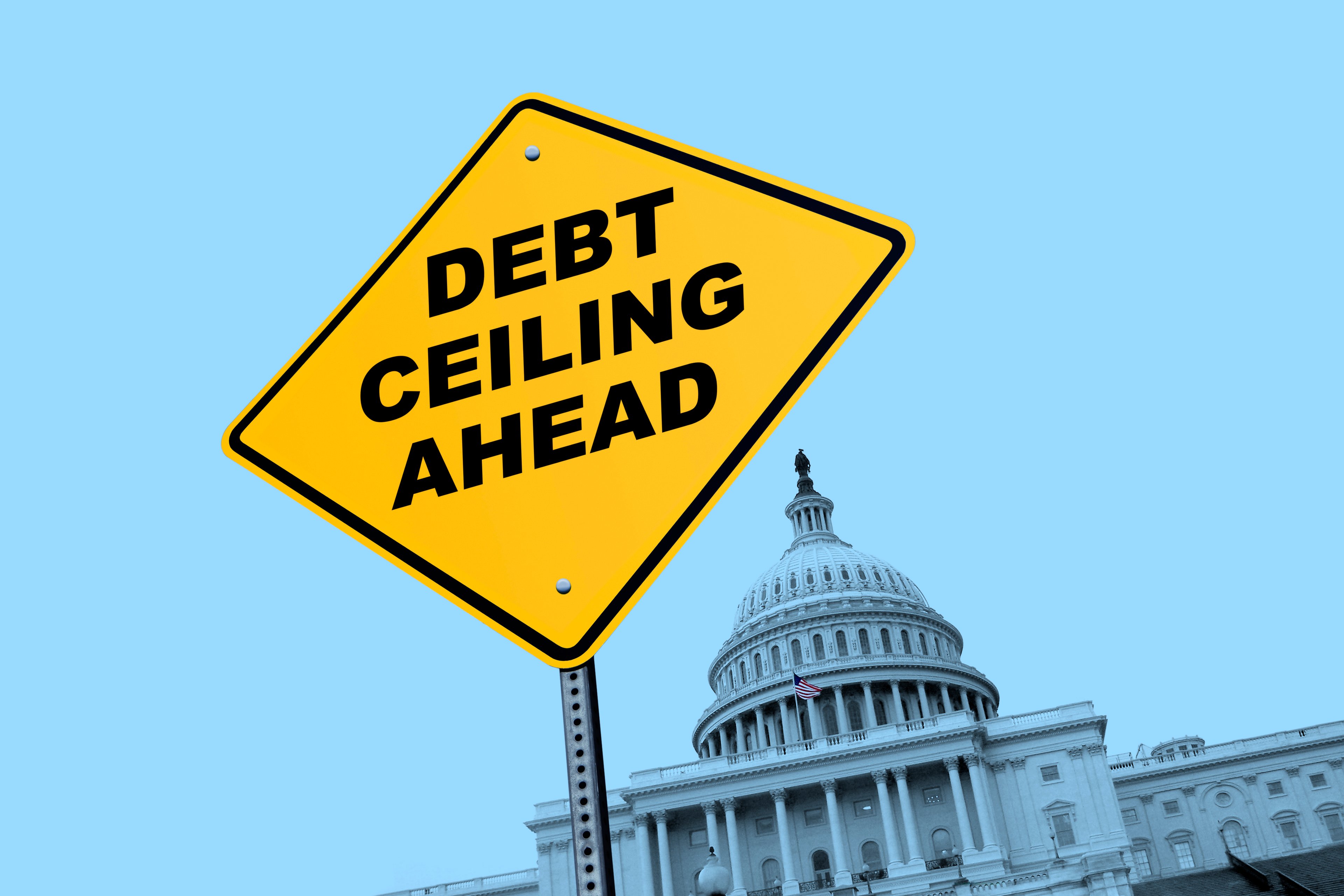Road sign with "debt ceiling ahead" written on it, in front of the US Capitol building.
