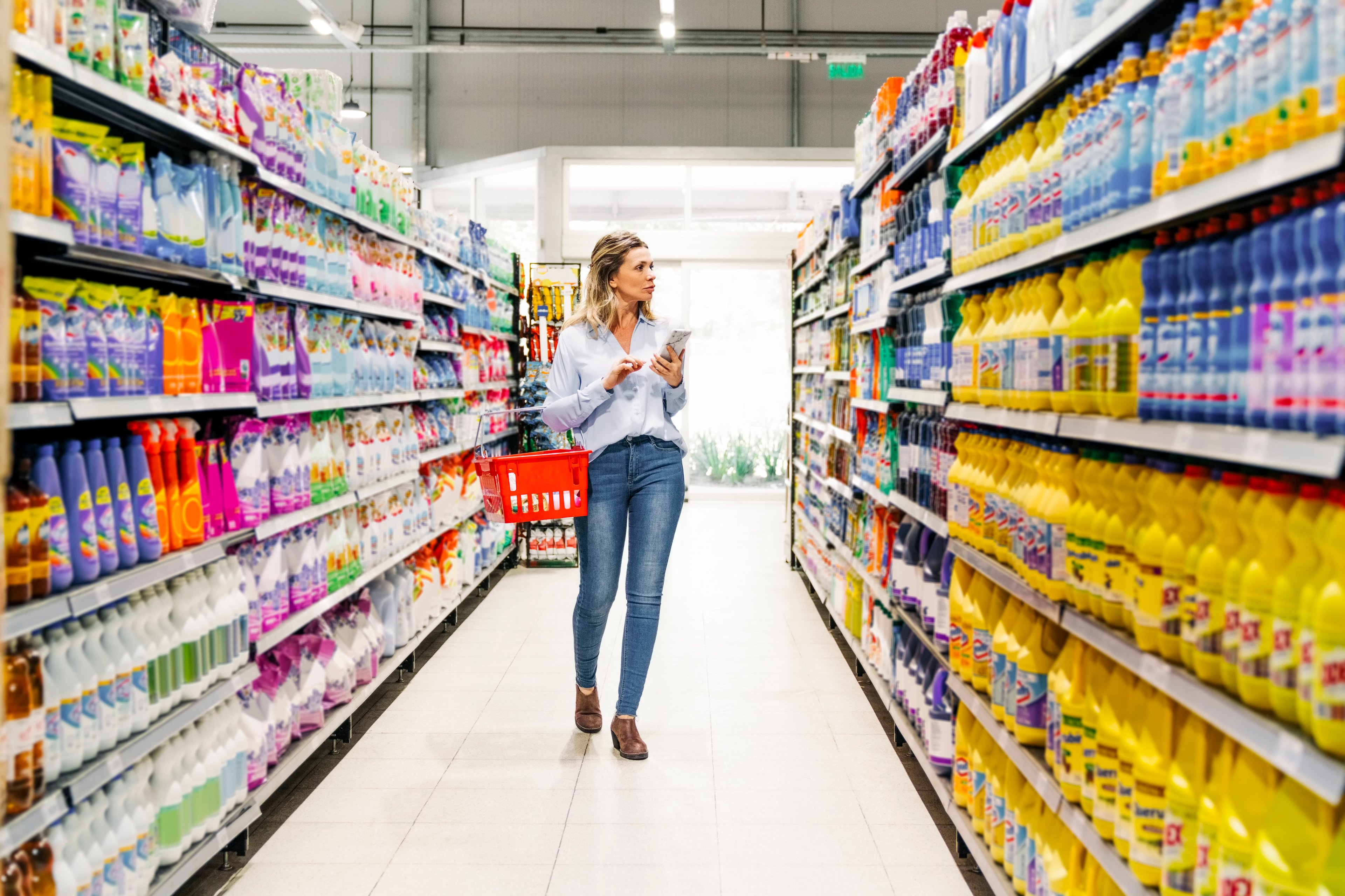 A consumer shopping for home necessities in a convenience store.