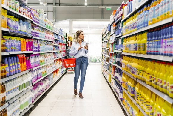 A consumer shopping for home necessities in a convenience store.