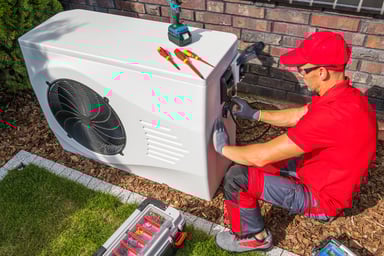 A technician reparing a modern heat pump unit