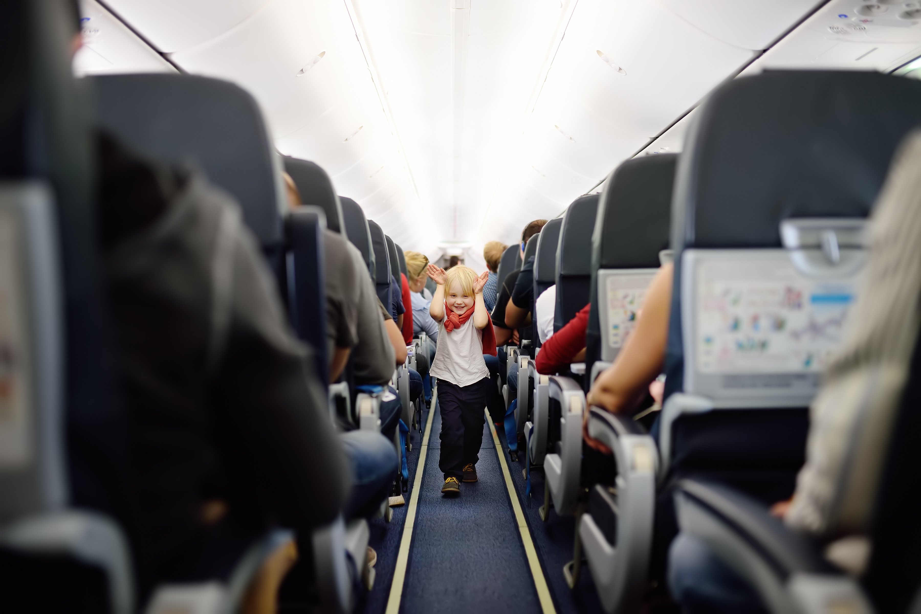 Happy little boy during traveling by an airplane