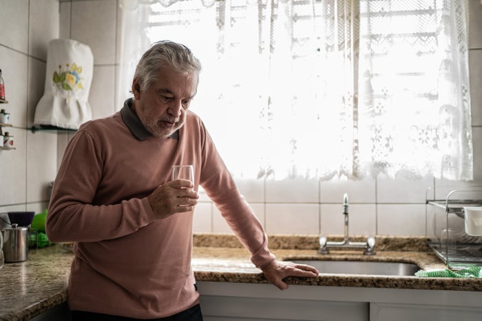 A depressed person in a kitchen.