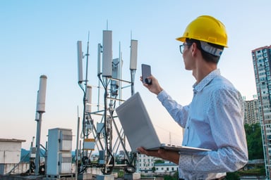 cell towers, guy in hard hat
