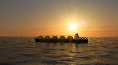 An LNG tanker at sea at sundown or sunrise