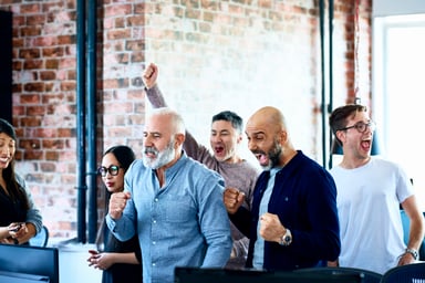 People in an office cheering.