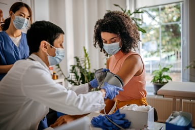 Doctor checking blood pressure