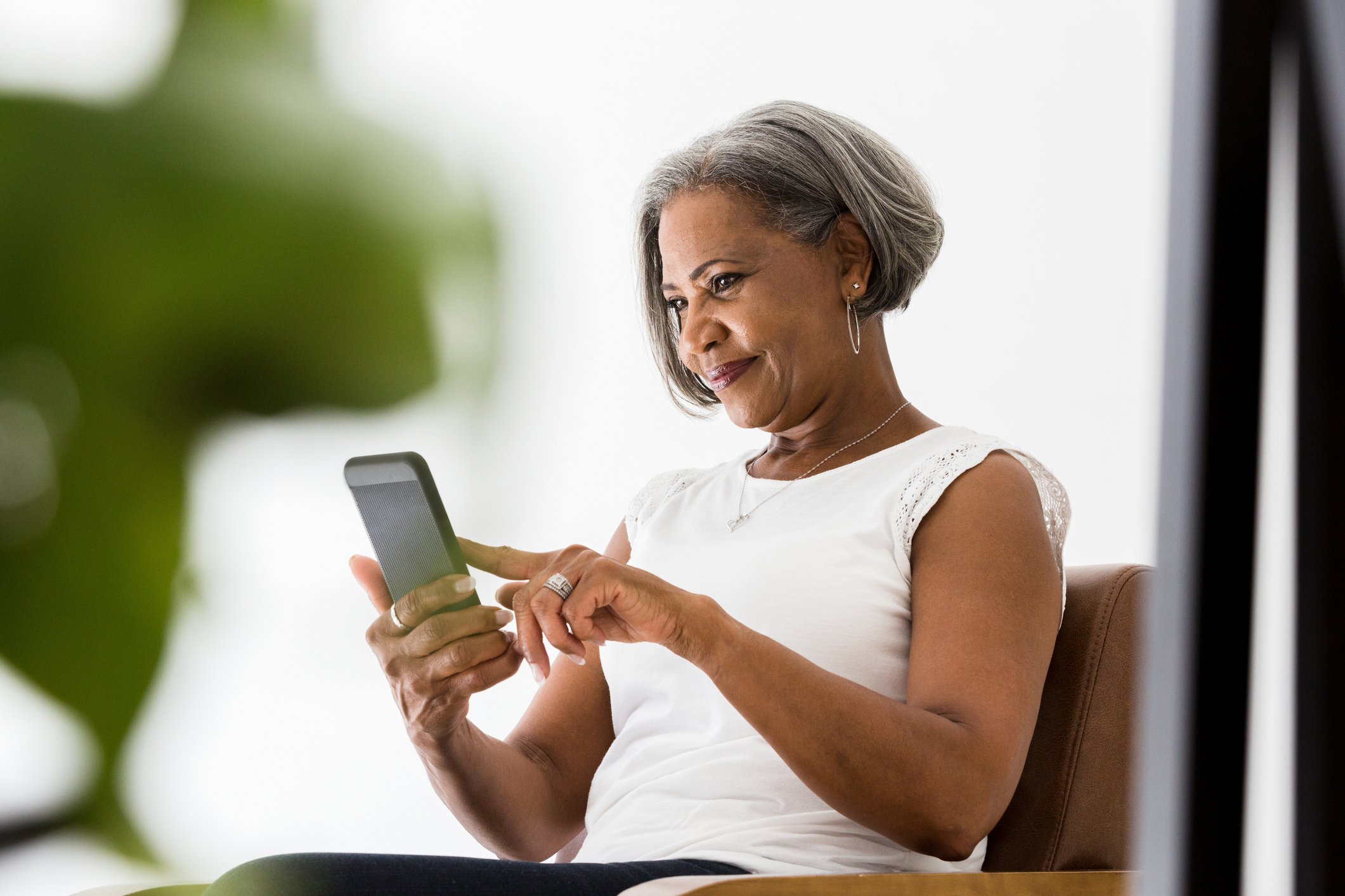 person smiles while using smartphone app