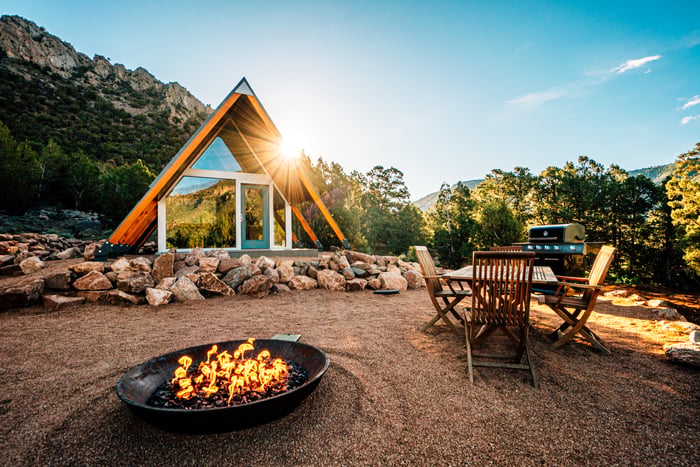 A vacation home with a firepit outside.