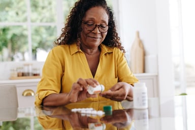 Older woman taking medication