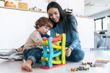 A person playing with her son with toys