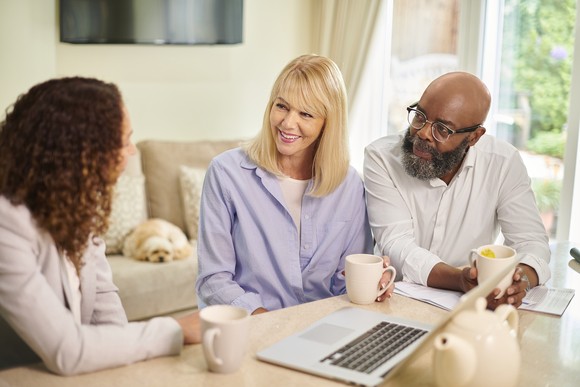 Two people consulting with a third person.