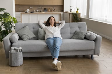 A person relaxing on a sofa.
