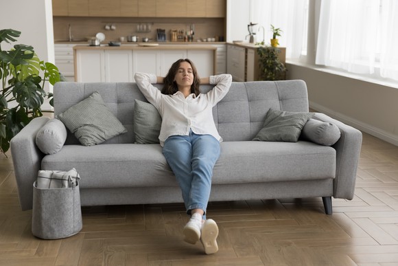 A person relaxing on a sofa.