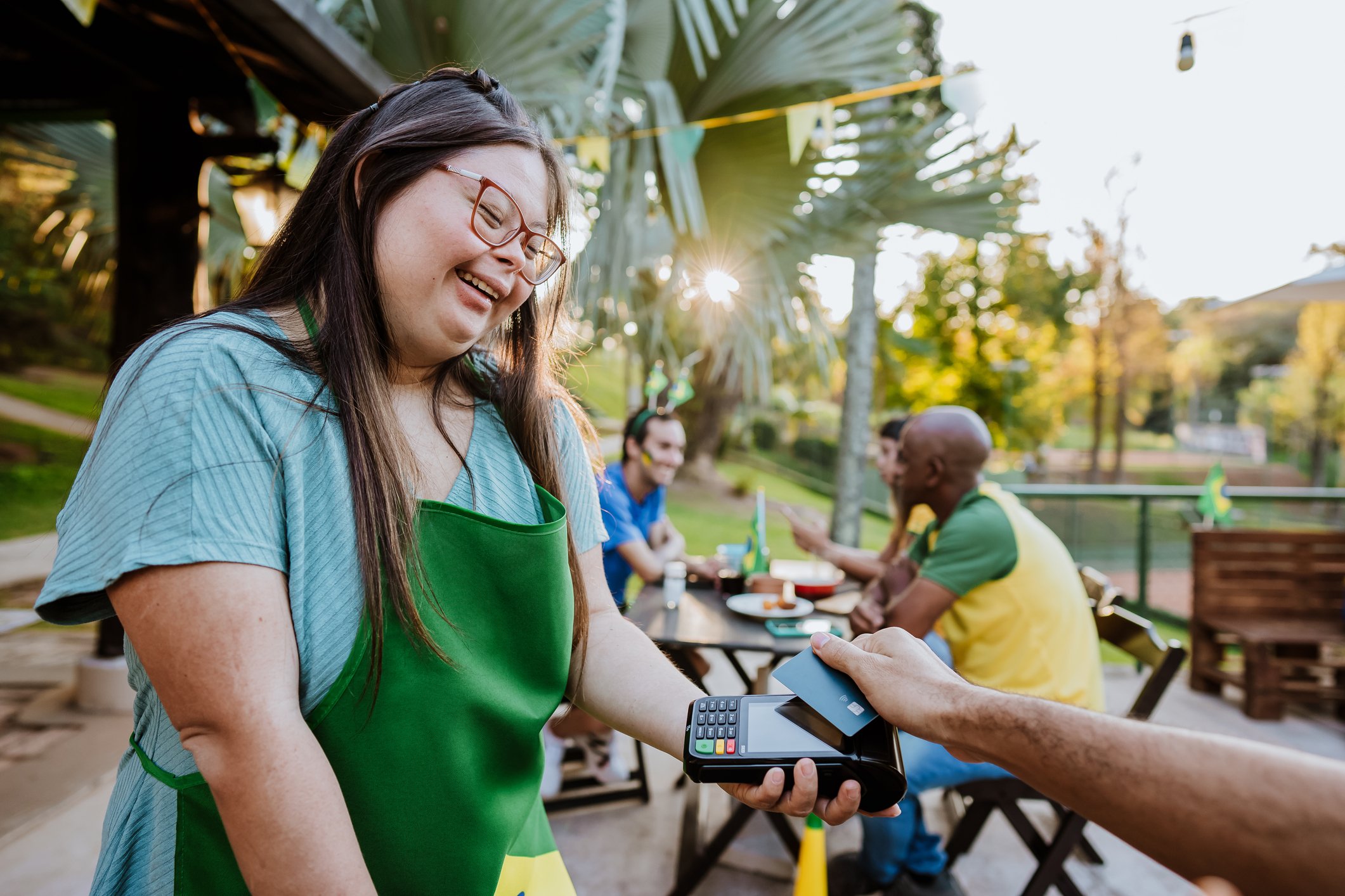 person takes payment at coffee shop getty 2022