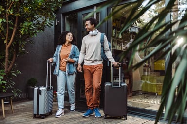 man and woman with trolley bags