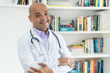 doctor looking at camera bookshelves