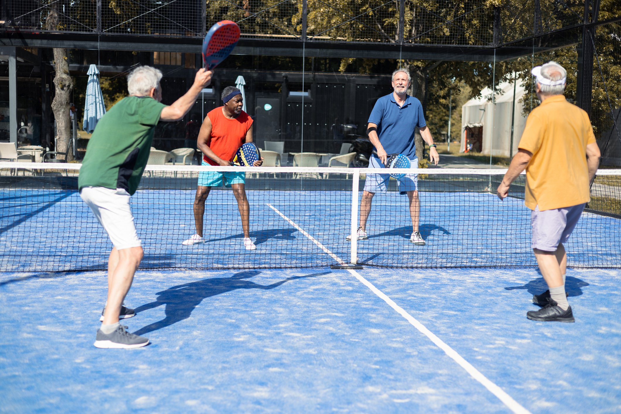Four people playing pickleball.