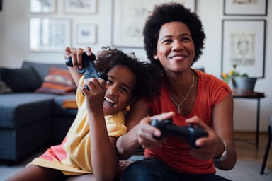 a child and parent play a computer game together