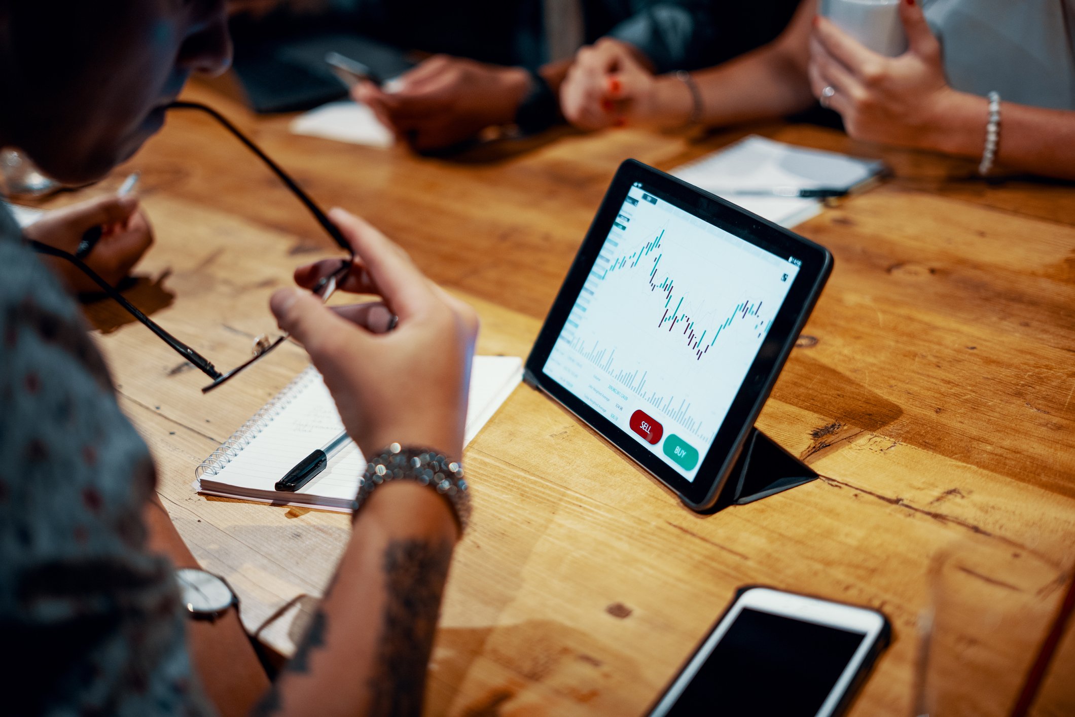 an investor looking at a stock chart on a tablet