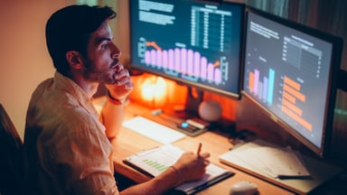 investor taking notes stock charts