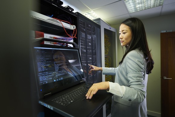 IT professional observing a monitor in a data center.