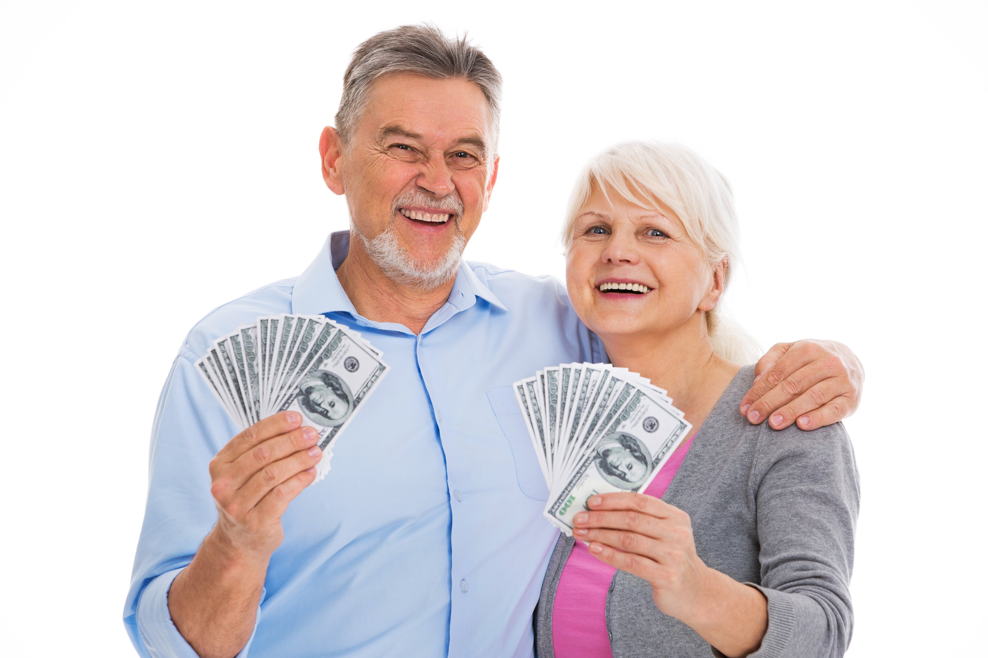 Smiling senior couple holding cash.