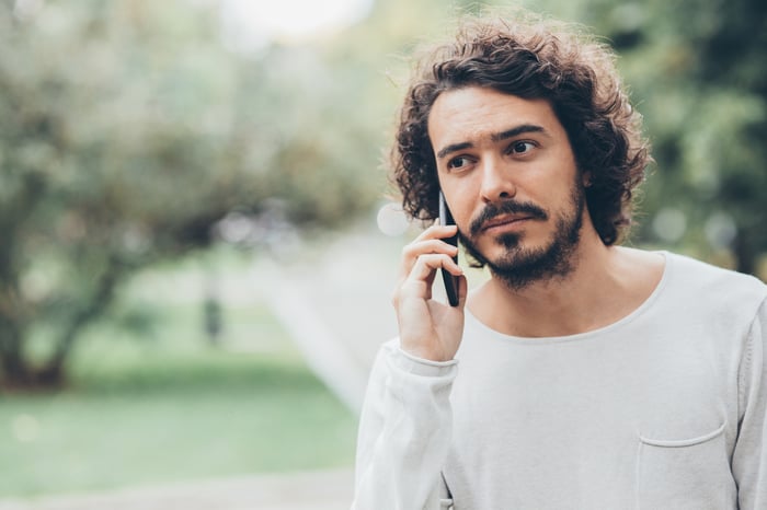 A person on a phone outdoors.