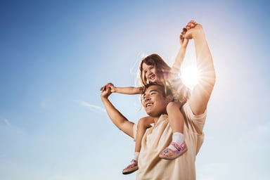 Adult and child gazing at sky during a sunny day