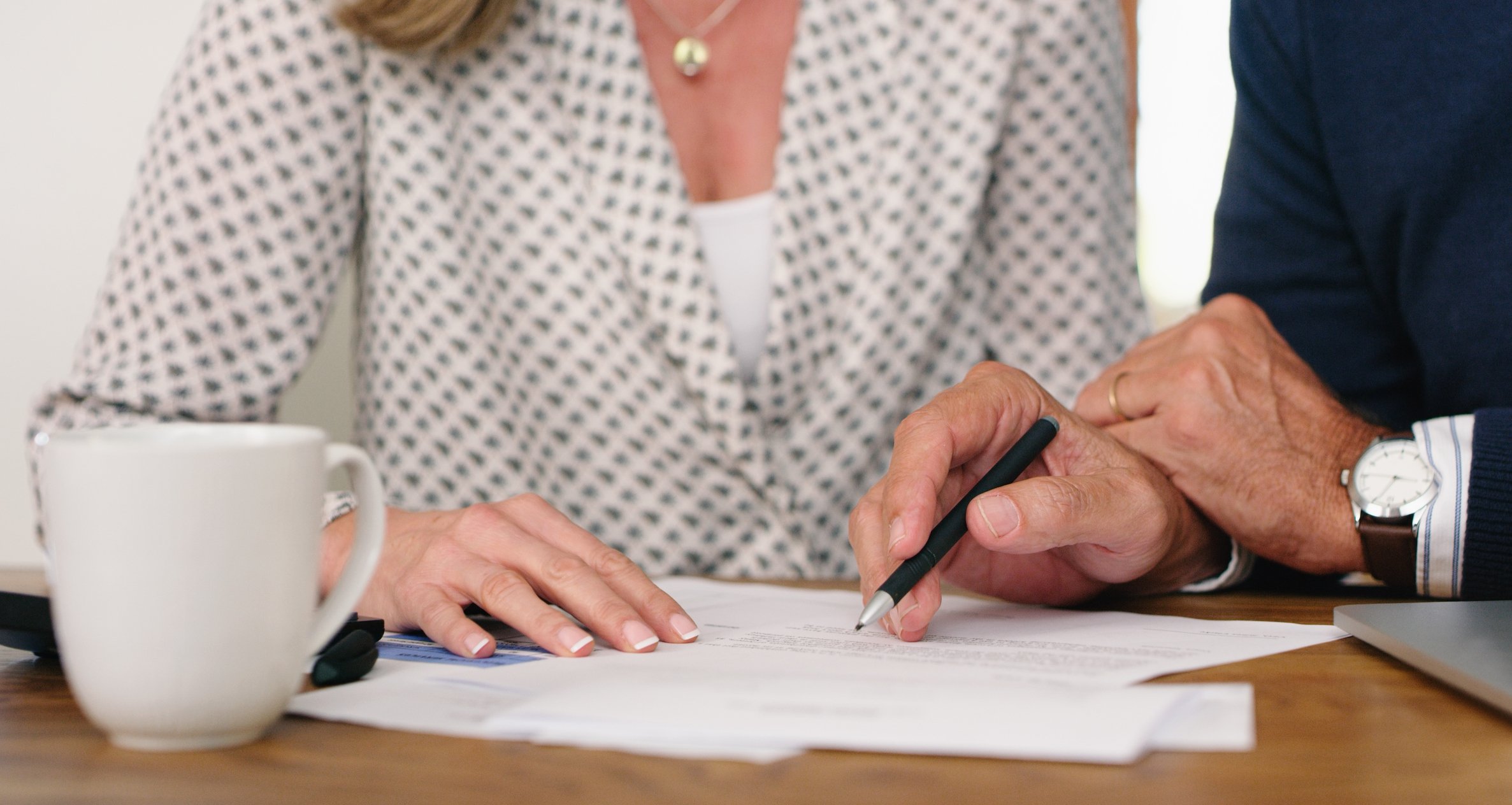 Two people signing forms together.