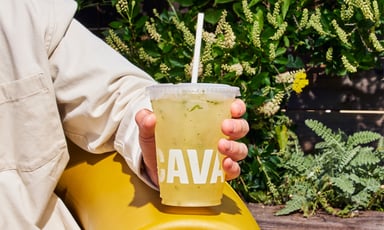person holding cup with cava logo in view_CAVA