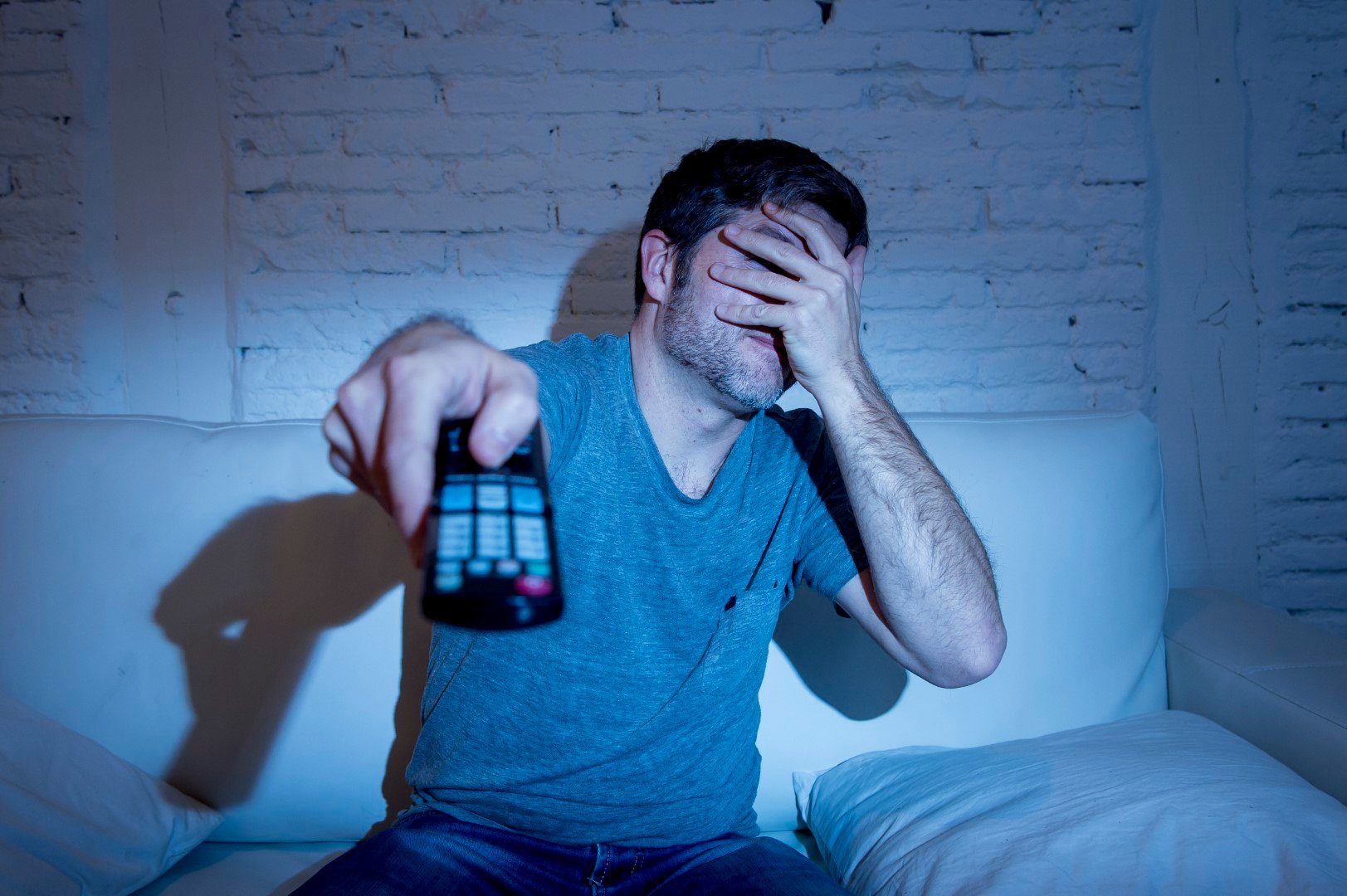 scared man watching tv streaming