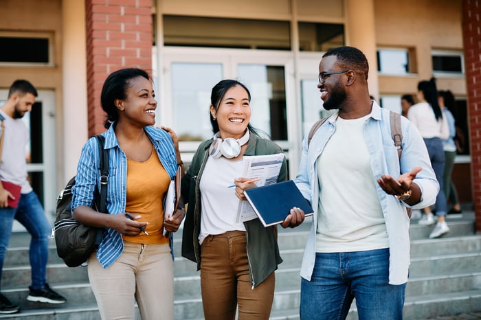 College students talking outside of classroom building. 