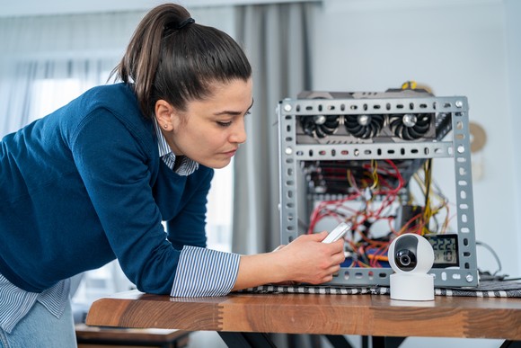 IT professional connecting graphics processor units to a security camera.