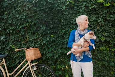 mature woman holding dog