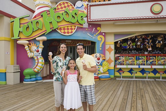 A family enjoying the day at a fun house.