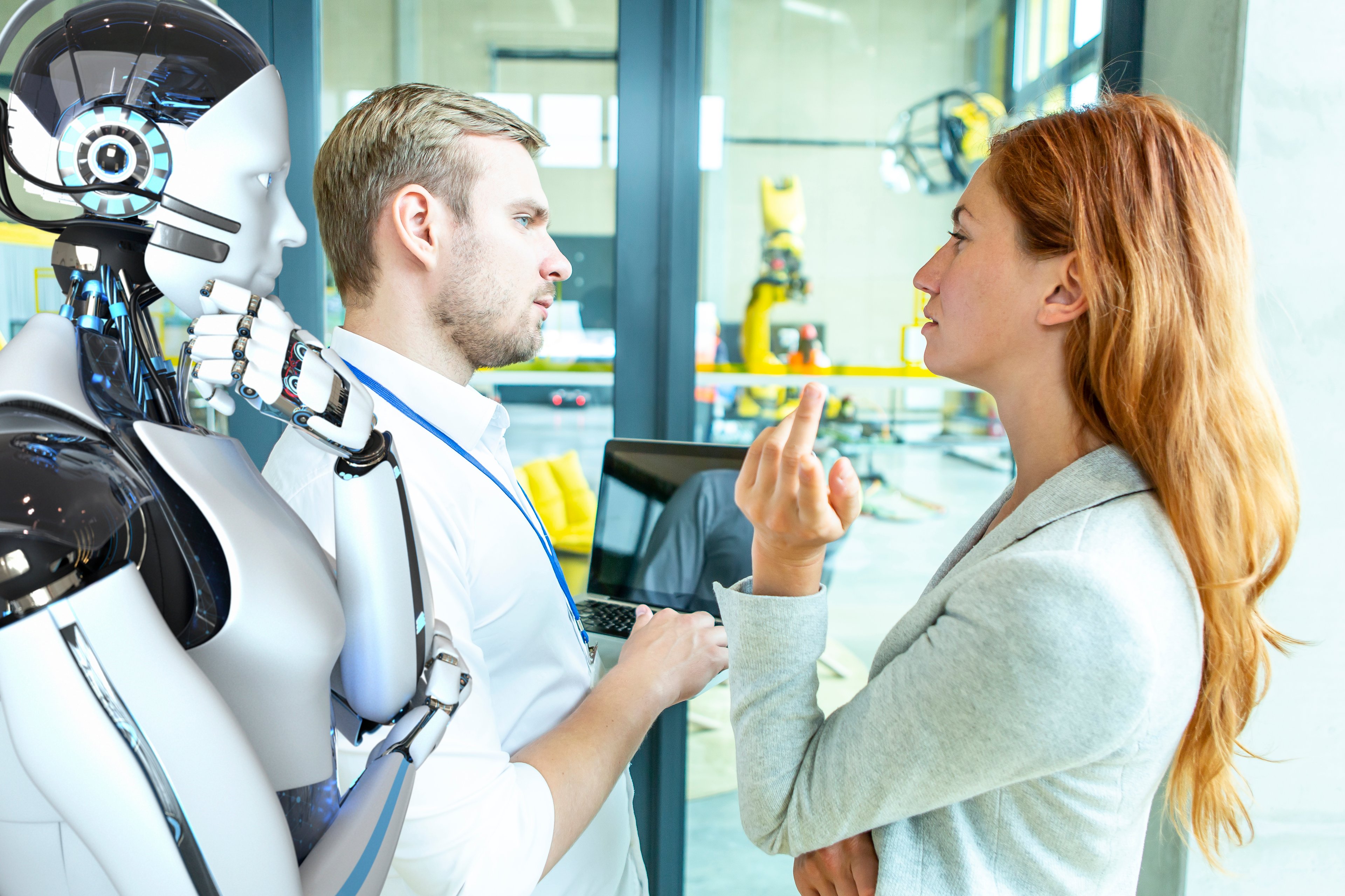 People interacting with a humanoid robot in a lab.
