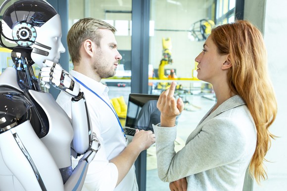 People interacting with a humanoid robot in a lab.