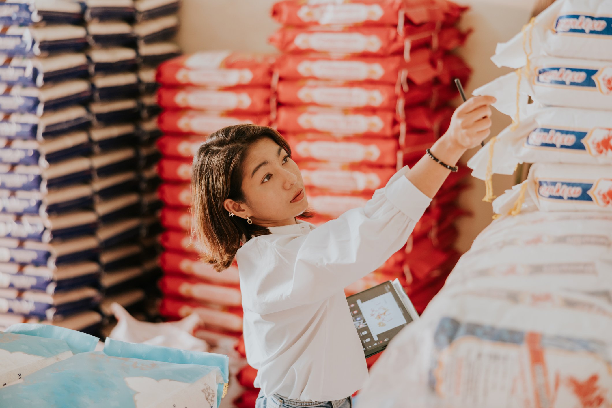 Person reaching for item in a warehouse.