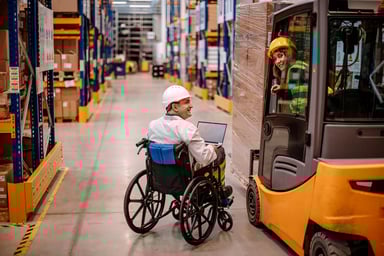 wheelchair worker and two other warehouse workers