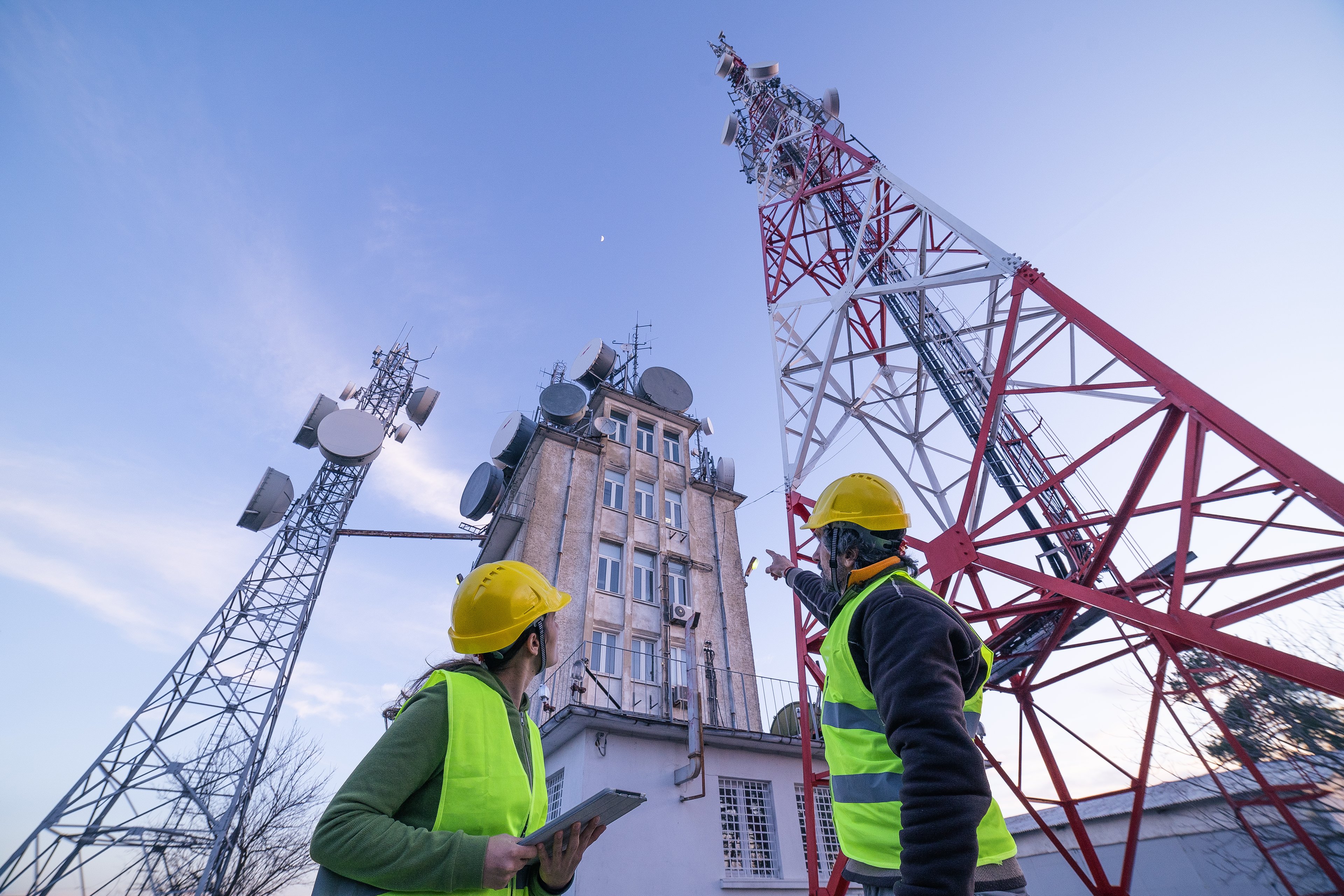 Workers at a construction site for a cell tower.