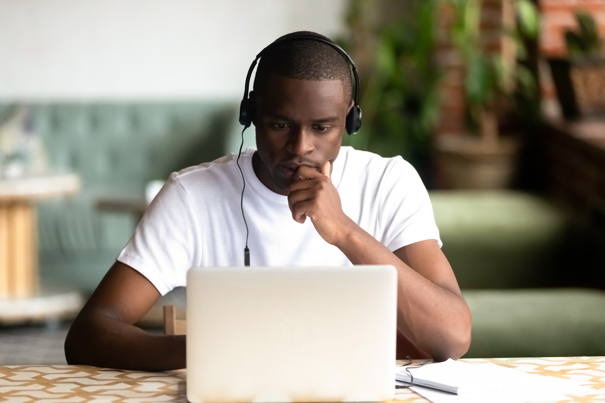 Getty - laptop serious headphones listening podcast