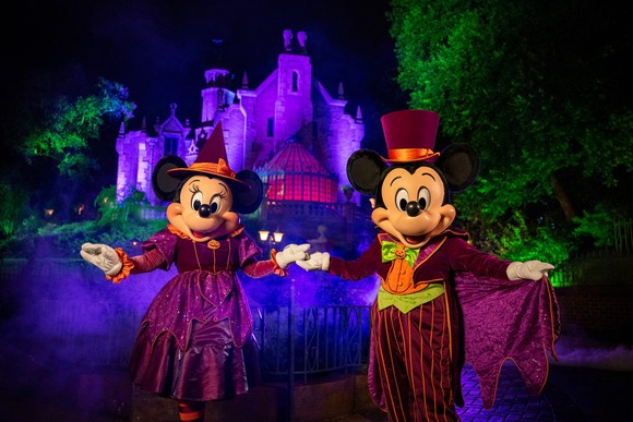 Minnie and Mickey wear Halloween outfits at Disney World.
