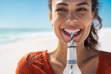 drinking soft drink on beach soda