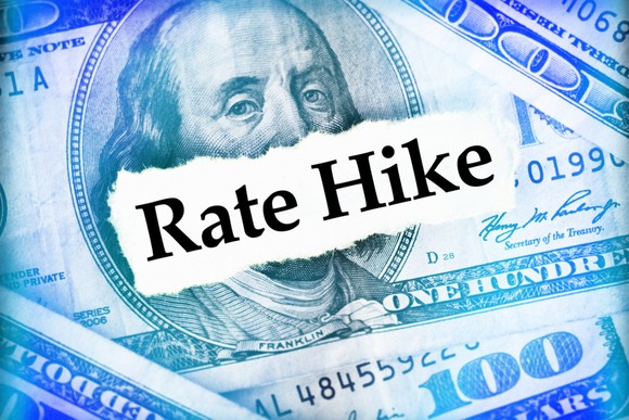 rate hike written on 100 dollar bill.