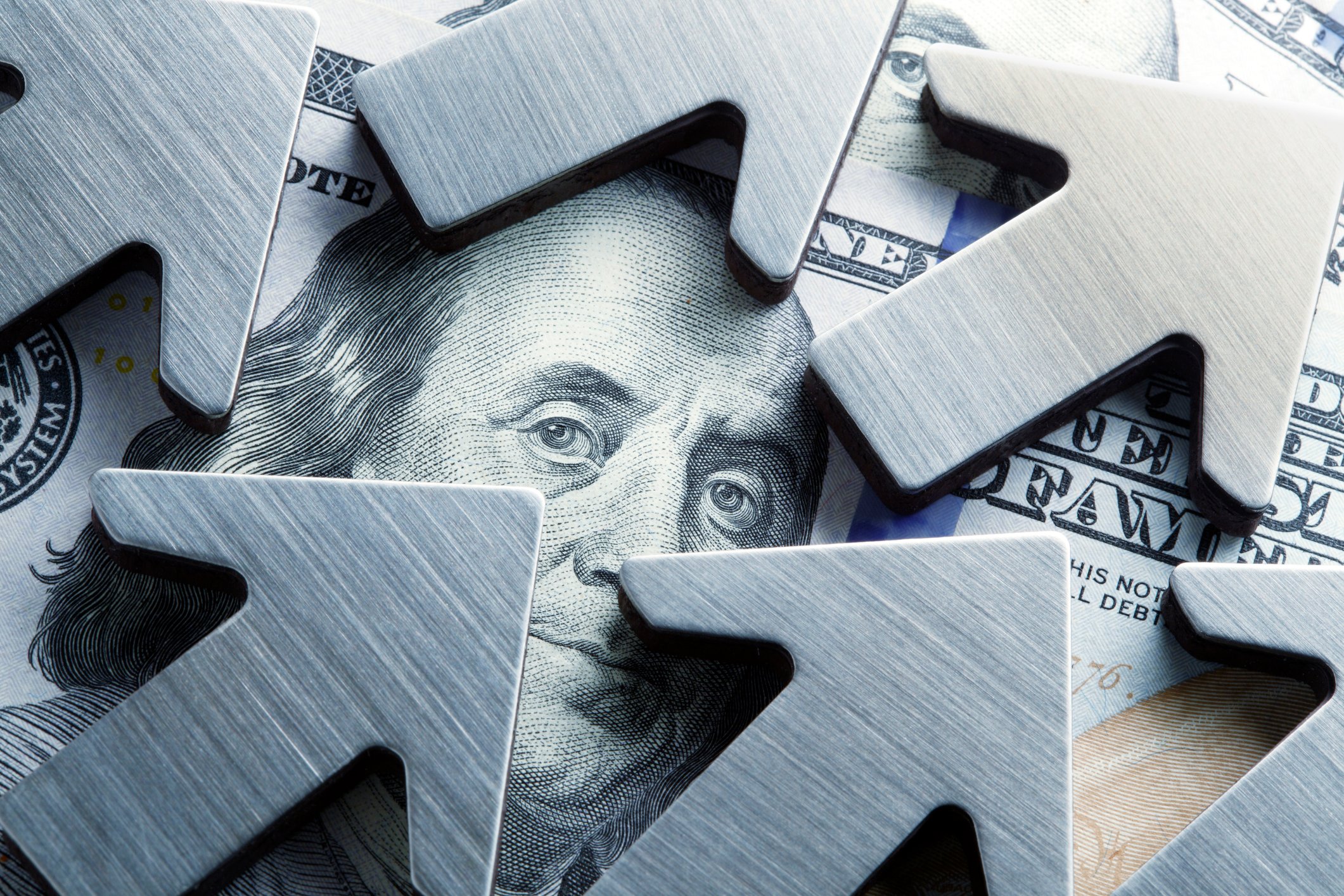 Arrows pointing up on a hundred-dollar bill.
