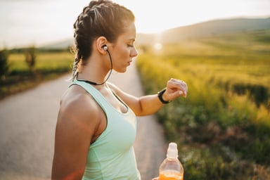 jogger drinks energy drink while outside