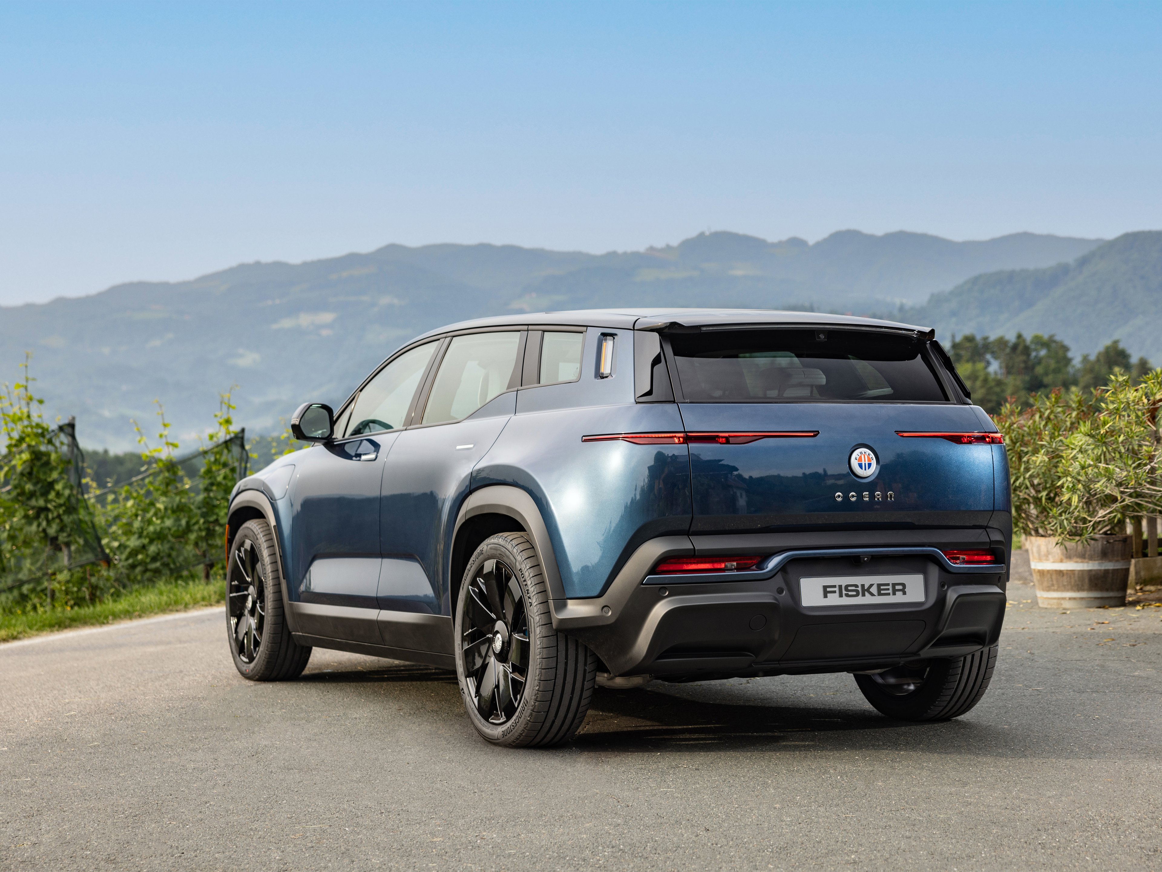A Fisker Ocean against a mountain backdrop.