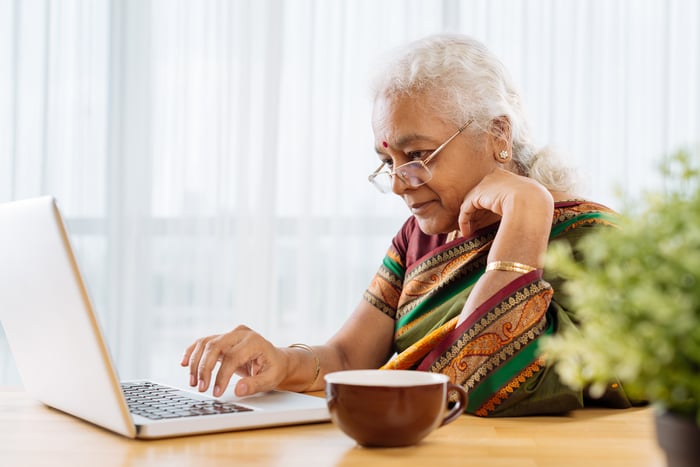 Serious person looking at laptop.