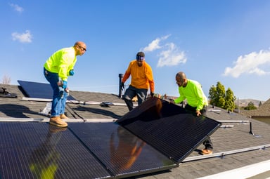 team installing solar panels renewable energy
